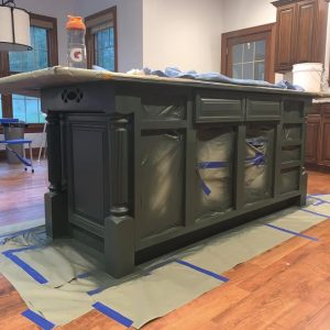 While painting the island in this new construction kitchen, we carefully taped and protected the surroundings to protect the home and ensure the mess is not left behind. It's tedious, but necessary work.